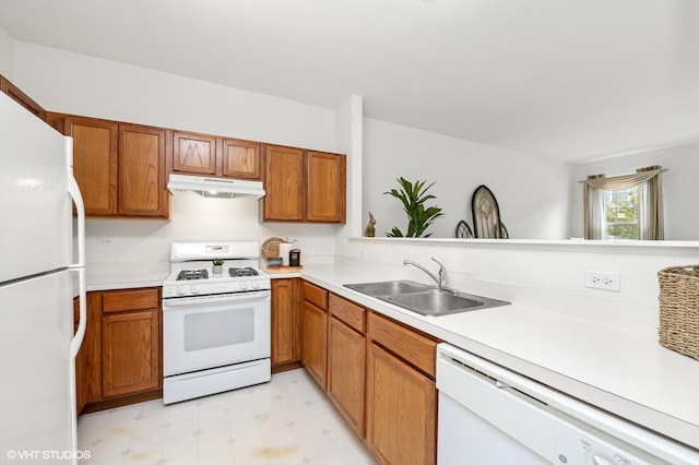 707 Morris Ct, Lakemoor, IL 60051 - kitchen with white appliances, a sink, under cabinet range hood, light countertops, and brown cabinets