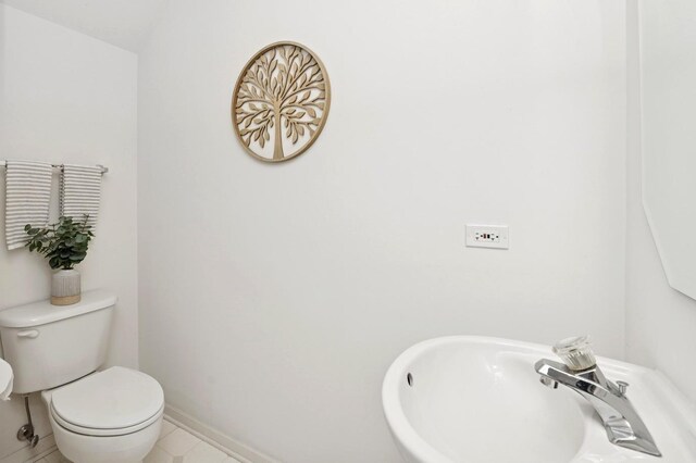 707 Morris Ct, Lakemoor, IL 60051 - half bathroom featuring a sink, toilet, tile patterned flooring, and baseboards