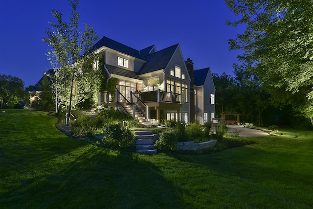 26285 W Roberts Ln, Barrington, IL 60010 - back of house at twilight featuring stairway, a wooden deck, and a lawn