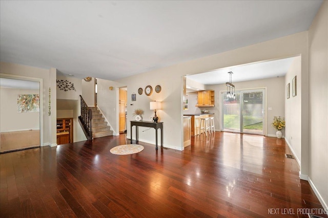 6416 W Rawson Bridge Rd W, Cary, IL 60013 - living room featuring stairs, wood-type flooring, baseboards, and a chandelier
