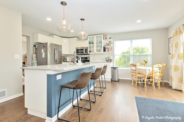 411 Lake Plumleigh Way, Algonquin, IL 60102 - kitchen with stainless steel appliances, white cabinetry, tasteful backsplash, wood finished floors, and recessed lighting