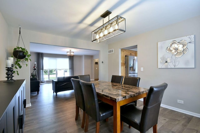 179 Old Forge Rd, Elgin, IL 60123 - dining room with dark wood-style floors, a chandelier, and baseboards