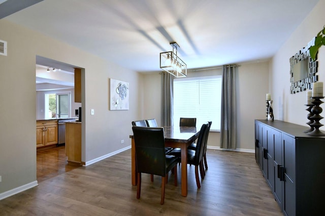 179 Old Forge Rd, Elgin, IL 60123 - dining area with dark wood-type flooring, baseboards, and a chandelier