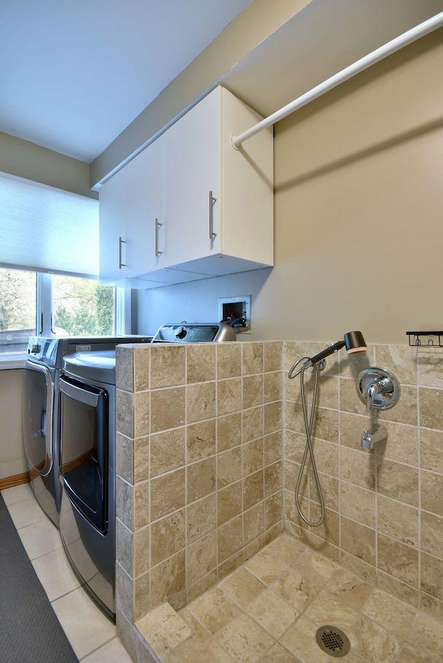 179 Old Forge Rd, Elgin, IL 60123 - laundry area featuring cabinet space, washing machine and dryer, and light tile patterned floors