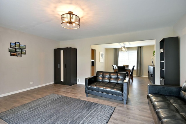 179 Old Forge Rd, Elgin, IL 60123 - living area featuring wood finished floors, baseboards, and a chandelier