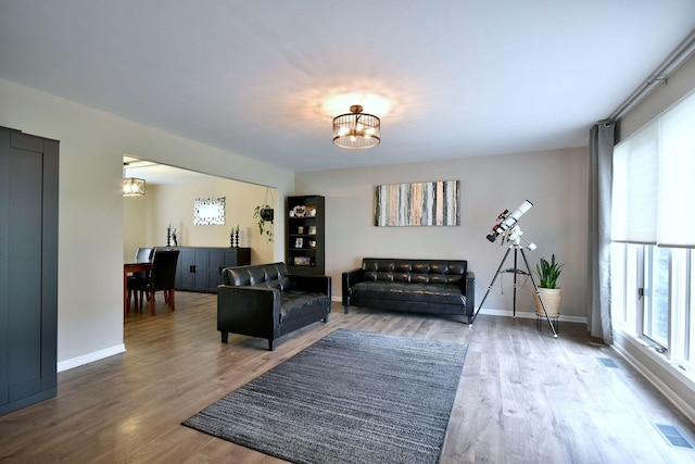 179 Old Forge Rd, Elgin, IL 60123 - living room featuring a chandelier, wood finished floors, and baseboards