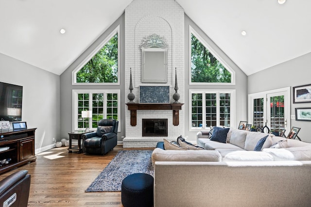 41W877 Hunters Rdg, Saint Charles, IL 60175 - living area featuring high vaulted ceiling, a brick fireplace, wood finished floors, and healthy amount of natural light