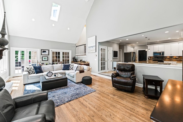 41W877 Hunters Rdg, Saint Charles, IL 60175 - living room featuring high vaulted ceiling, light wood finished floors, french doors, a skylight, and recessed lighting