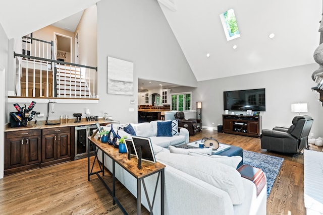 41W877 Hunters Rdg, Saint Charles, IL 60175 - living room featuring high vaulted ceiling, wine cooler, bar area, a skylight, and light wood-style floors