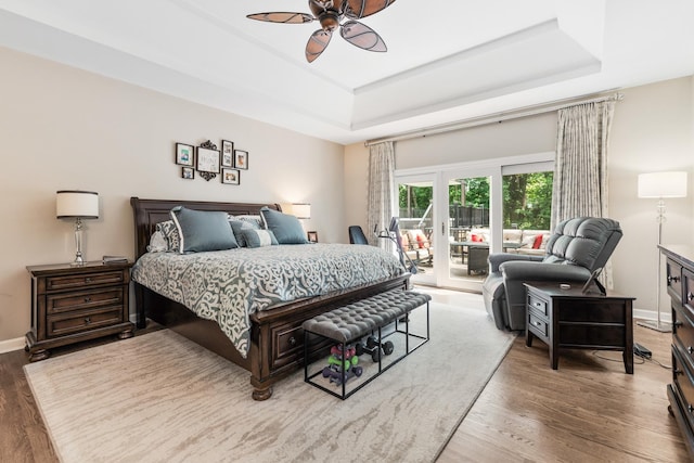41W877 Hunters Rdg, Saint Charles, IL 60175 - bedroom featuring access to exterior, a tray ceiling, wood finished floors, and a ceiling fan