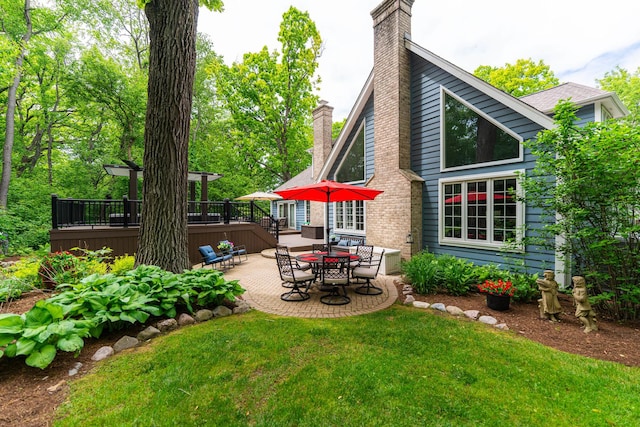 41W877 Hunters Rdg, Saint Charles, IL 60175 - back of property featuring a chimney, a deck, a yard, and a patio