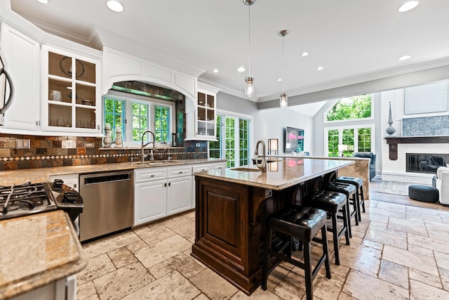 41W877 Hunters Rdg, Saint Charles, IL 60175 - kitchen featuring stainless steel dishwasher, stone tile floors, crown molding, open floor plan, and tasteful backsplash