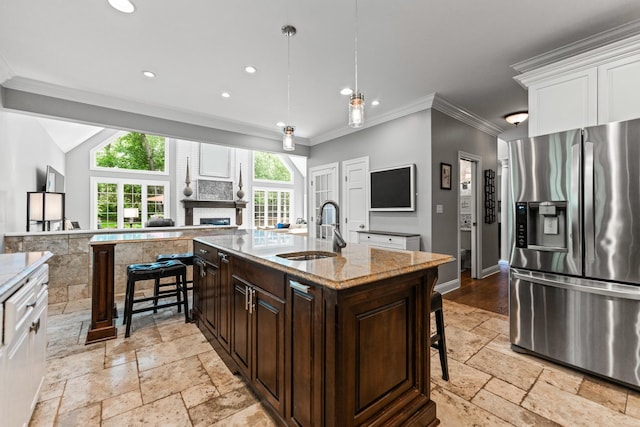 41W877 Hunters Rdg, Saint Charles, IL 60175 - kitchen featuring stainless steel fridge with ice dispenser, stone tile floors, a kitchen breakfast bar, dark brown cabinetry, and white cabinetry