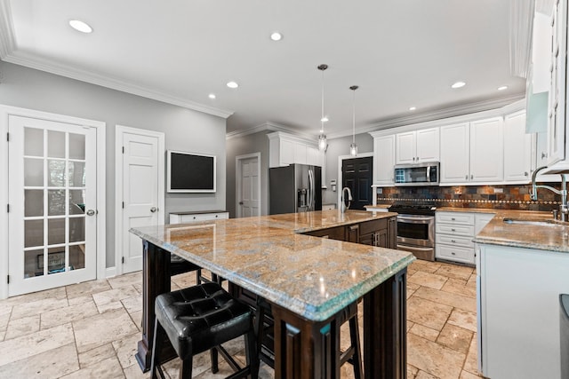 41W877 Hunters Rdg, Saint Charles, IL 60175 - kitchen featuring appliances with stainless steel finishes, stone tile floors, crown molding, a kitchen island with sink, and recessed lighting