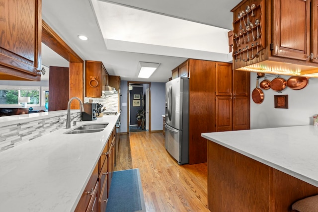 22W300 Arbor Ln, Glen Ellyn, IL 60137 - kitchen featuring appliances with stainless steel finishes, a sink, light wood-type flooring, brown cabinetry, and recessed lighting