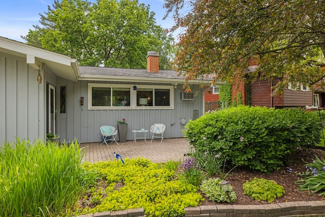 22W300 Arbor Ln, Glen Ellyn, IL 60137 - view of front of house with a chimney, a patio, and board and batten siding