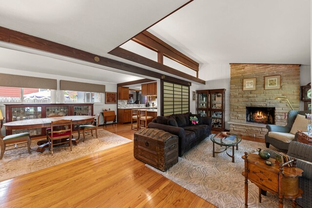 22W300 Arbor Ln, Glen Ellyn, IL 60137 - living room with light wood-style flooring, a stone fireplace, and vaulted ceiling