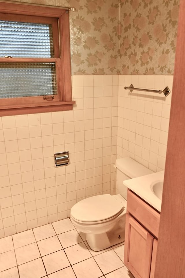 17315 Bryant Ln, Hazel Crest, IL 60429 - half bathroom with wallpapered walls, a wainscoted wall, tile walls, vanity, and toilet