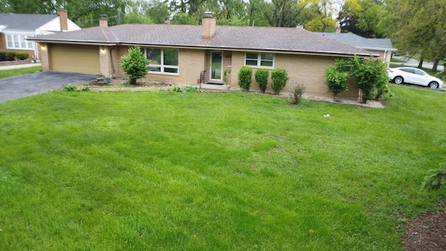 17315 Bryant Ln, Hazel Crest, IL 60429 - ranch-style home featuring a chimney, an attached garage, driveway, a front yard, and brick siding