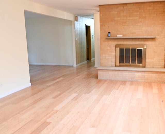 17315 Bryant Ln, Hazel Crest, IL 60429 - unfurnished living room with a brick fireplace, baseboards, and wood finished floors