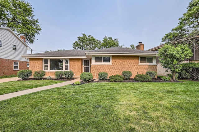 807 S Saylor Ave, Elmhurst, IL 60126 - view of front of house featuring brick siding, a front yard, and a chimney