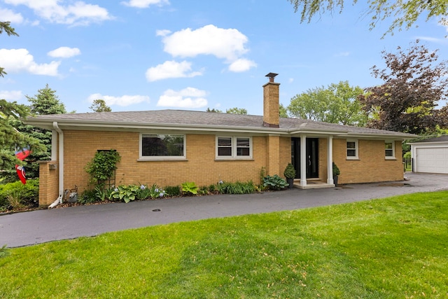 581 Summerdale Ave, Glen Ellyn, IL 60137 - view of front of house featuring a front yard, a chimney, brick siding, and a detached garage
