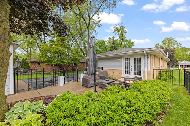 581 Summerdale Ave, Glen Ellyn, IL 60137 - back of house with a fire pit, brick siding, french doors, a patio, and a fenced backyard