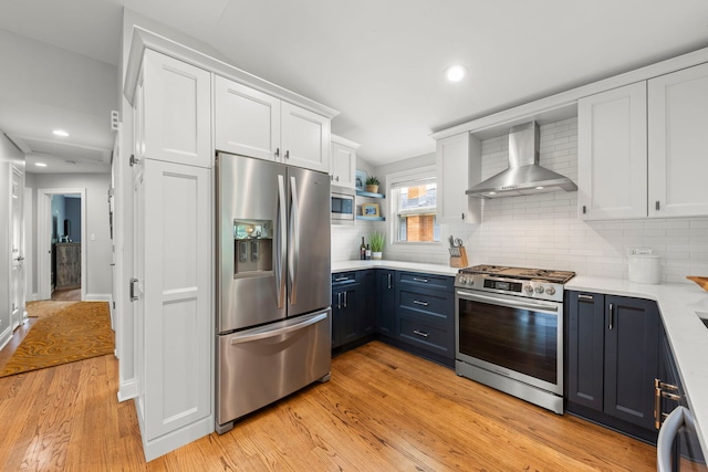 581 Summerdale Ave, Glen Ellyn, IL 60137 - kitchen with stainless steel appliances, a sink, wall chimney range hood, a peninsula, and plenty of natural light