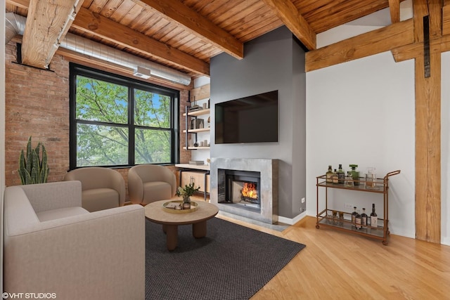 3201 N Ravenswood Ave Unit 203, Chicago, IL 60657 - living room with wood finished floors, wooden ceiling with exposed beams, a high end fireplace, and baseboards
