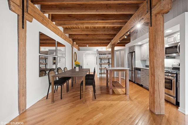 3201 N Ravenswood Ave Unit 203, Chicago, IL 60657 - dining room featuring light wood-type flooring, wooden ceiling with exposed beams, and baseboards