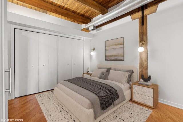 3201 N Ravenswood Ave Unit 203, Chicago, IL 60657 - bedroom featuring wood ceiling with exposed beams, a closet, wood finished floors, and baseboards