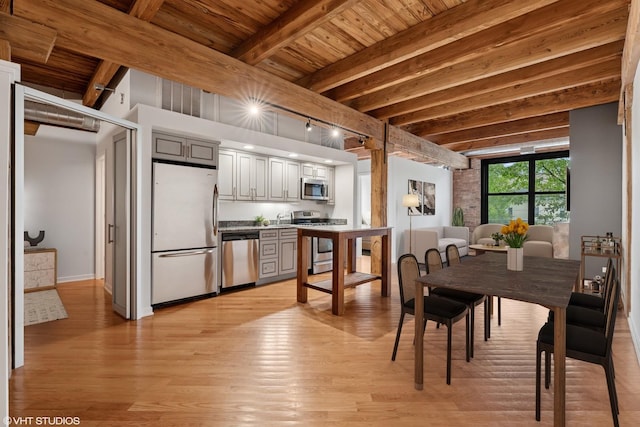3201 N Ravenswood Ave Unit 203, Chicago, IL 60657 - dining space featuring light wood-style floors, wood ceiling with exposed beams, and baseboards