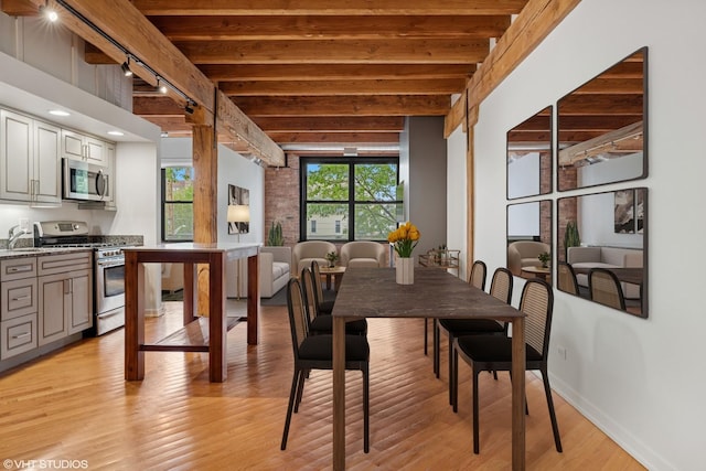 3201 N Ravenswood Ave Unit 203, Chicago, IL 60657 - dining space featuring beam ceiling, light wood-style floors, and baseboards