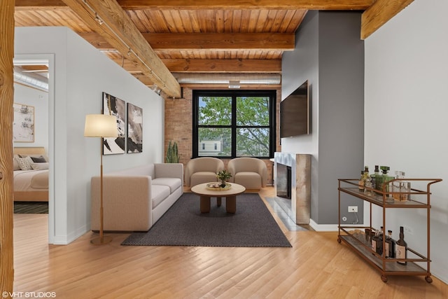 3201 N Ravenswood Ave Unit 203, Chicago, IL 60657 - living area featuring a premium fireplace, wooden ceiling with exposed beams, wood finished floors, and baseboards