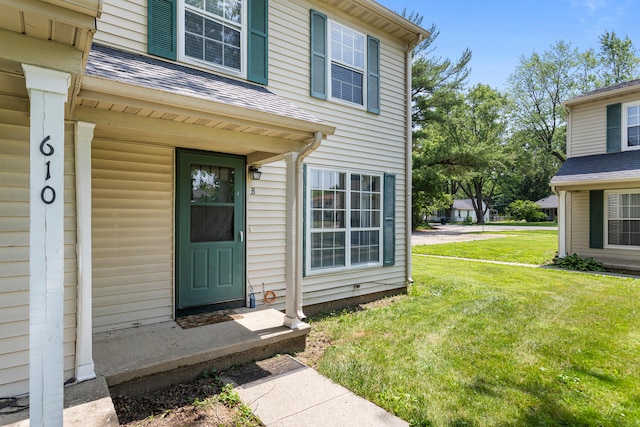 610 English Creek Ct Unit B, Champaign, IL 61821 - doorway to property with a yard and a shingled roof