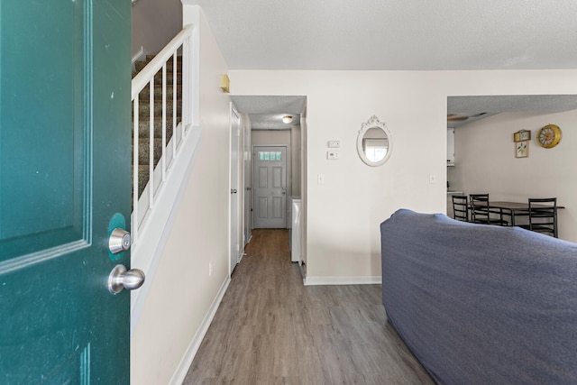 610 English Creek Ct Unit B, Champaign, IL 61821 - entryway with wood finished floors, stairs, and a textured ceiling