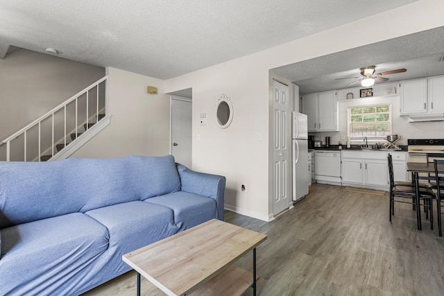610 English Creek Ct Unit B, Champaign, IL 61821 - living area with ceiling fan, wood finished floors, a textured ceiling, and stairway