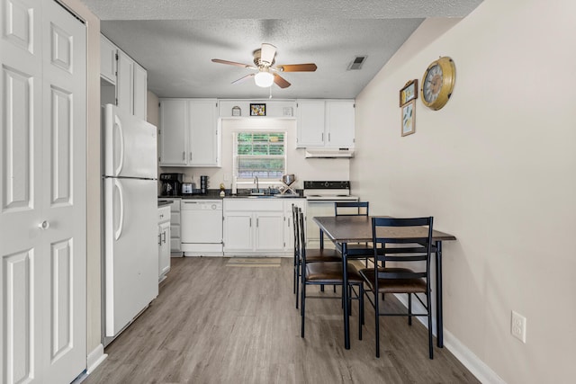 610 English Creek Ct Unit B, Champaign, IL 61821 - kitchen featuring white appliances, ceiling fan, light wood-style floors, dark countertops, and white cabinets