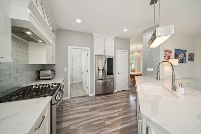 2205 Miramar Ct, Buffalo Grove, IL 60089 - kitchen with stainless steel appliances, custom range hood, a sink, white cabinetry, and decorative backsplash