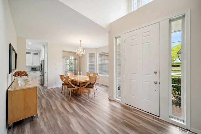 2205 Miramar Ct, Buffalo Grove, IL 60089 - foyer featuring a chandelier, light wood-type flooring, and baseboards