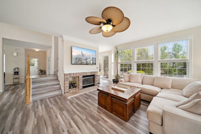 2205 Miramar Ct, Buffalo Grove, IL 60089 - living room featuring light wood finished floors, a fireplace, ceiling fan, and stairway