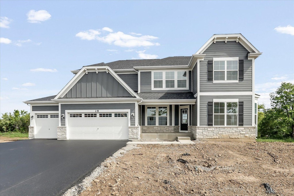 28 Open Pkwy, Hawthorn Woods, IL 60047 - craftsman house with stone siding, board and batten siding, driveway, an attached garage, and a shingled roof