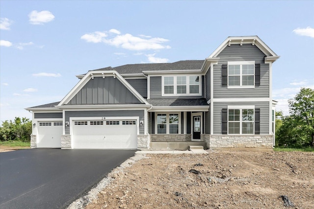 28 Open Pkwy, Hawthorn Woods, IL 60047 - craftsman house with stone siding, board and batten siding, driveway, an attached garage, and a shingled roof