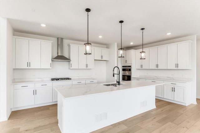 28 Open Pkwy, Hawthorn Woods, IL 60047 - kitchen with wall chimney exhaust hood, a sink, gas cooktop, light wood-style flooring, and stainless steel double oven