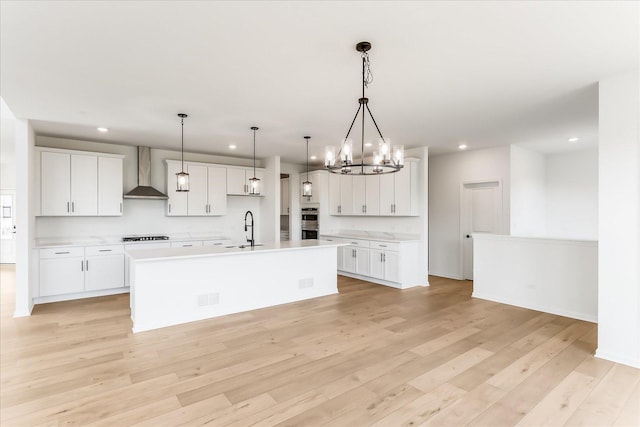 28 Open Pkwy, Hawthorn Woods, IL 60047 - kitchen featuring wall chimney exhaust hood, a sink, recessed lighting, light countertops, and a center island with sink