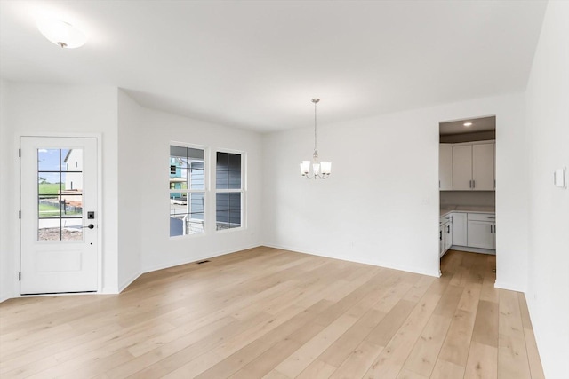 28 Open Pkwy, Hawthorn Woods, IL 60047 - unfurnished dining area with a chandelier and light wood-type flooring