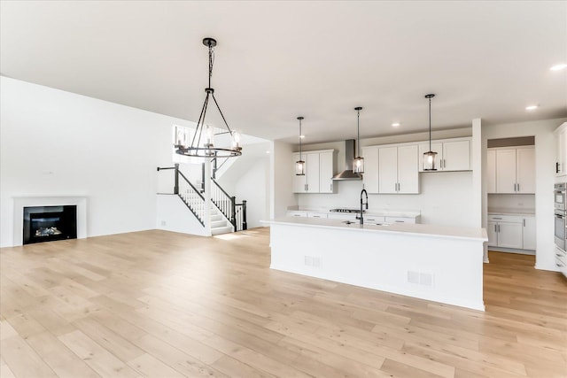 28 Open Pkwy, Hawthorn Woods, IL 60047 - kitchen with wall chimney exhaust hood, open floor plan, recessed lighting, a sink, and light countertops