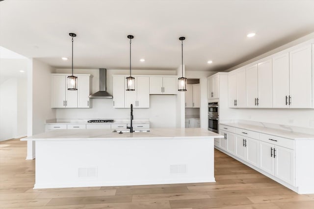 28 Open Pkwy, Hawthorn Woods, IL 60047 - kitchen with wall chimney exhaust hood, gas stovetop, double oven, light countertops, and light wood-style floors