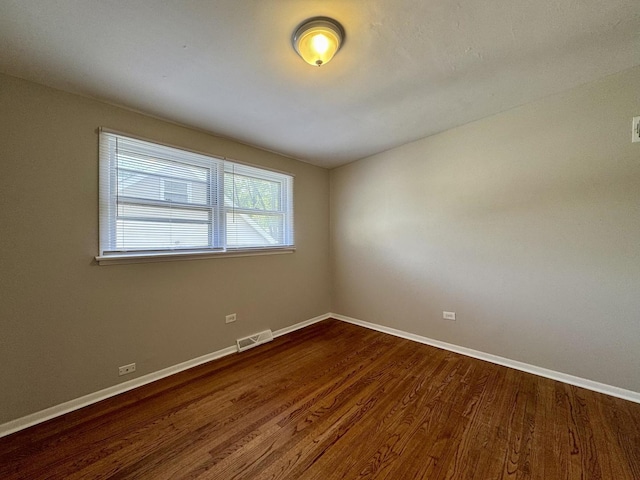 14401 Kolin Ave, Midlothian, IL 60445 - empty room with dark wood-style floors and baseboards