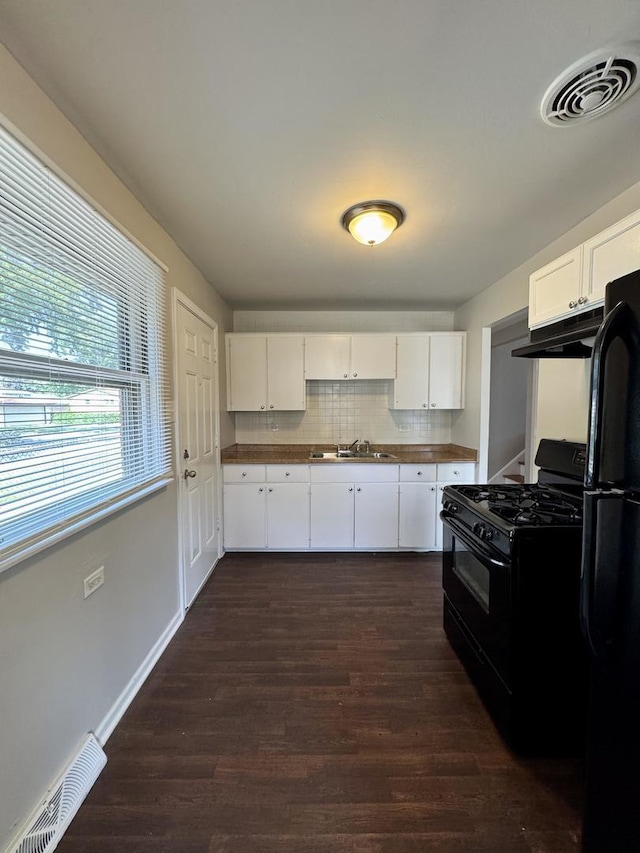 14401 Kolin Ave, Midlothian, IL 60445 - kitchen with black appliances, extractor fan, white cabinets, dark wood-style flooring, and dark countertops
